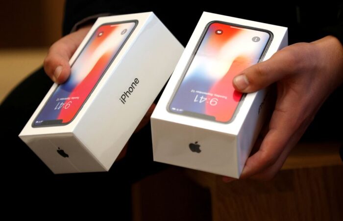 FILE-PHOTO-A-man-holds-two-boxes-for-the-Apples-new-iPhone-X-at-the-Apple-Store-in-Regents-Street