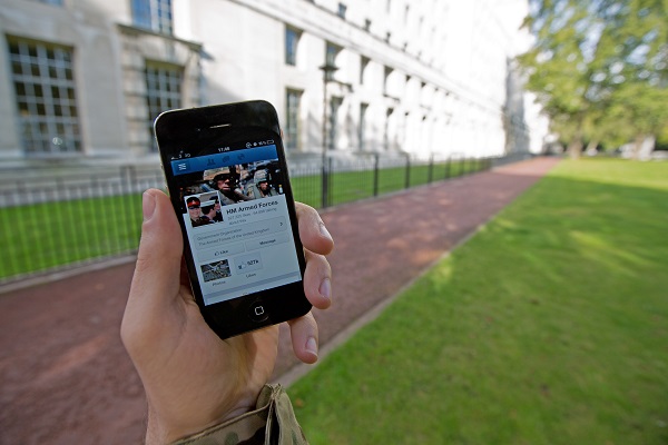 A_serviceman_accesses_social_media_channels_using_a_smart_phone,_outside_MOD_Main_Building_in_London_MOD_45156045